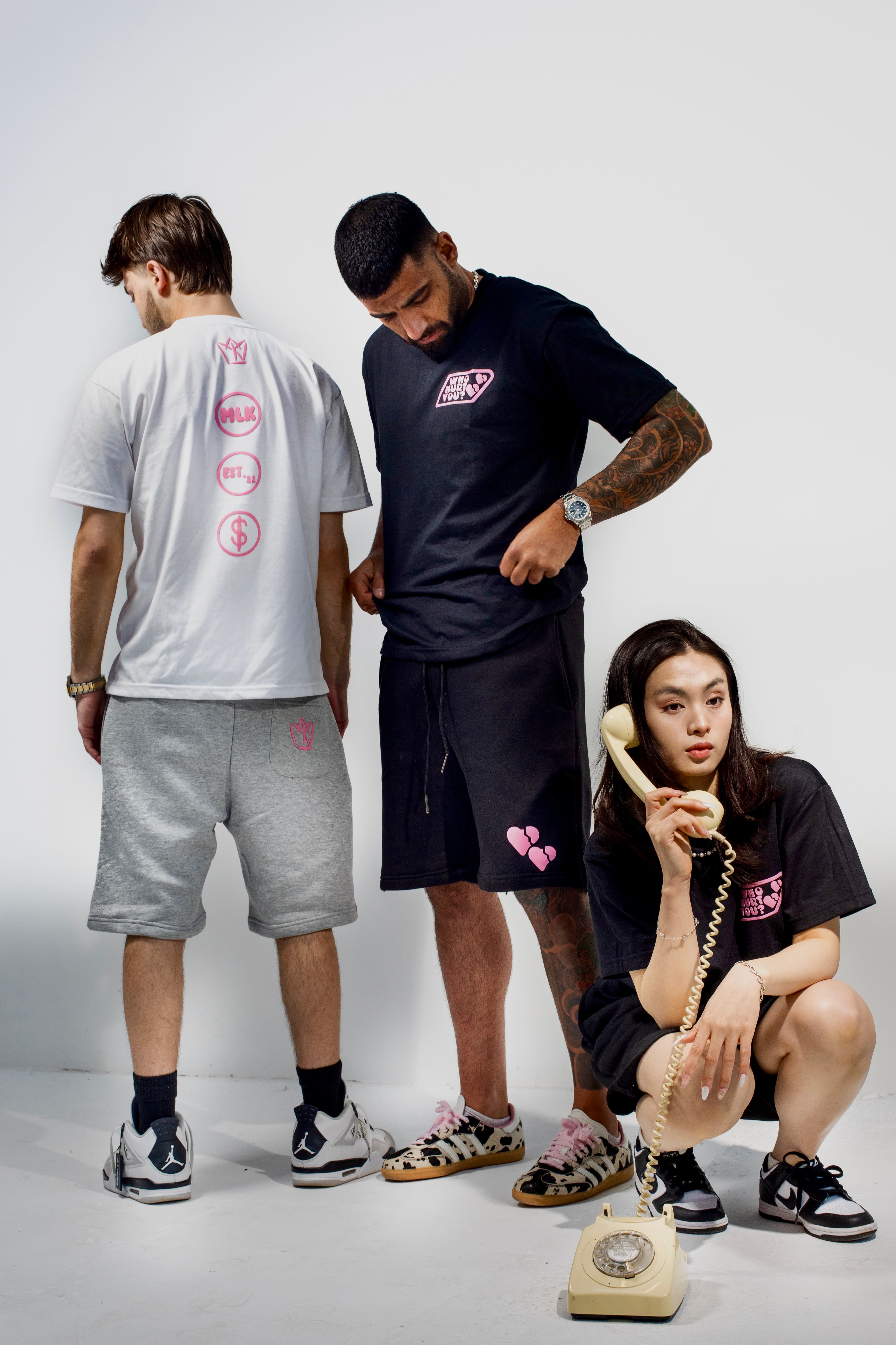 Three models stood in studio wearing MLK shorts, and t-shirt
