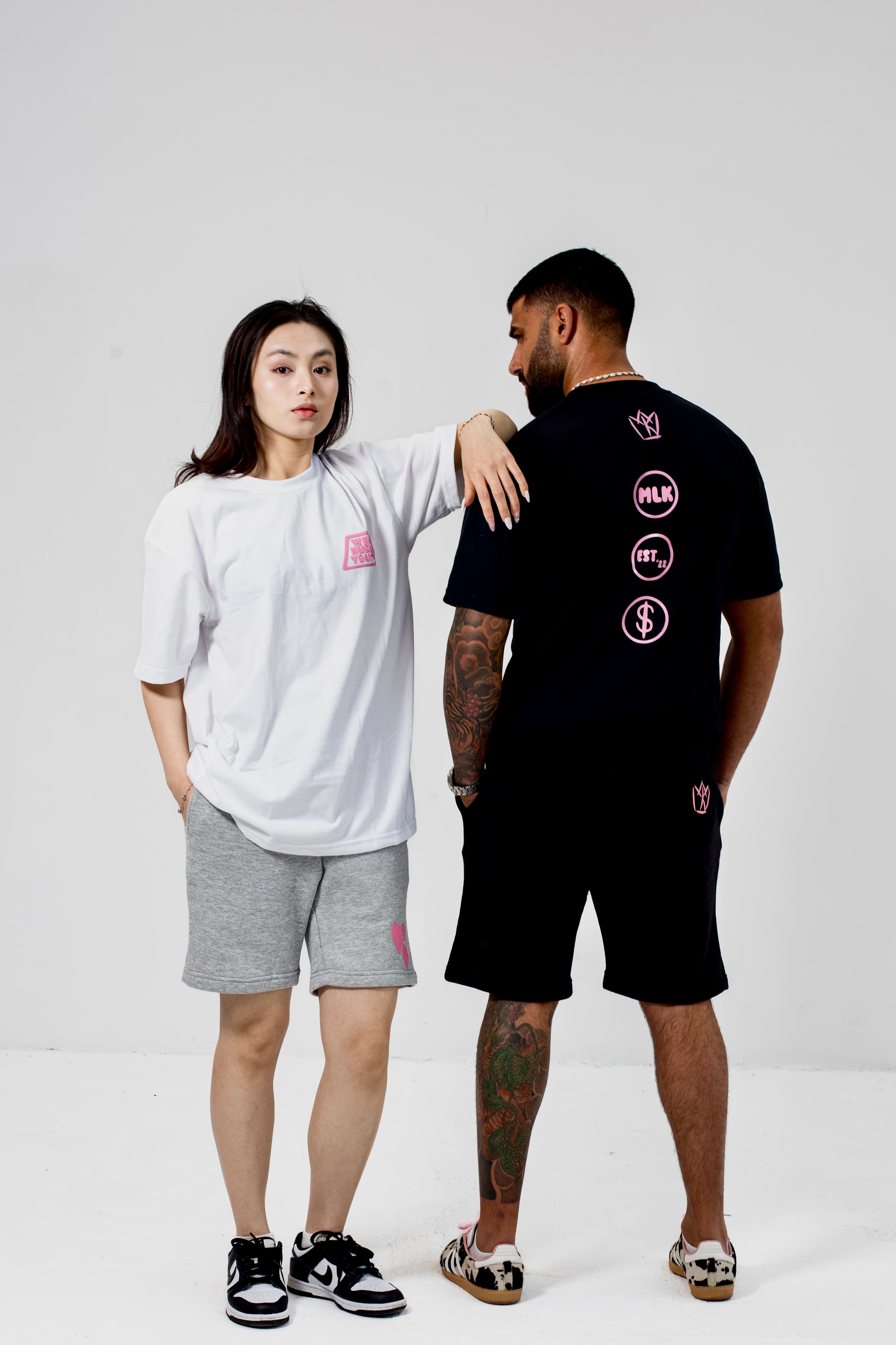 Two models stood in studio wearing MLK shorts, and t-shirt